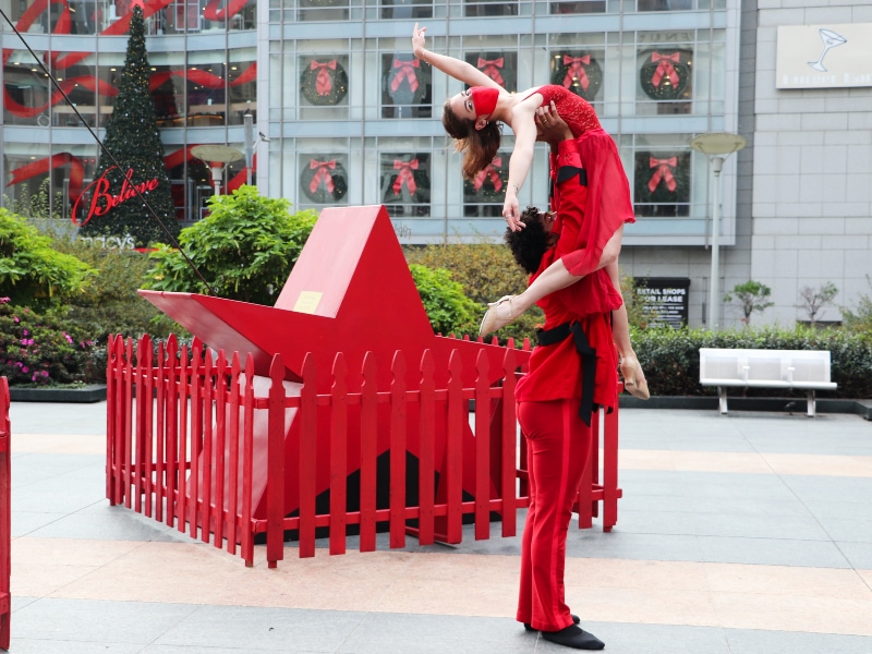 Brennan Wall and Ricardo Dyer in an over head press sporting costumes from The Christmas Ballet, photo by Chris Hardy