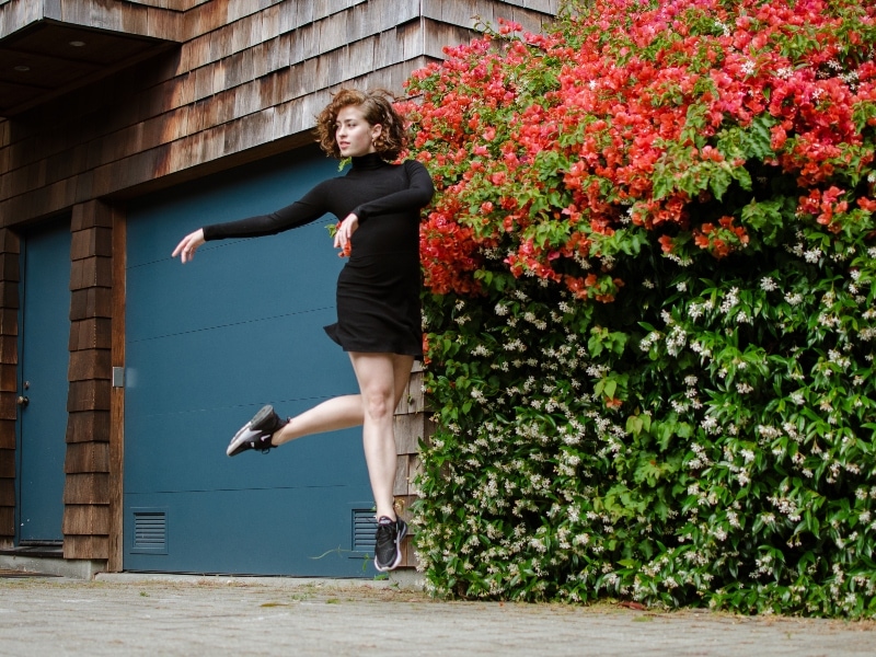 Brennan Wall jumping in front of a wall of bougainvillea, photo by Maggie Carey