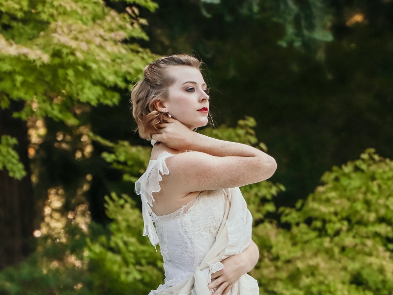 Cassidy Isaacson looking off into the distance performing outside, photo by Tessa Barbour
