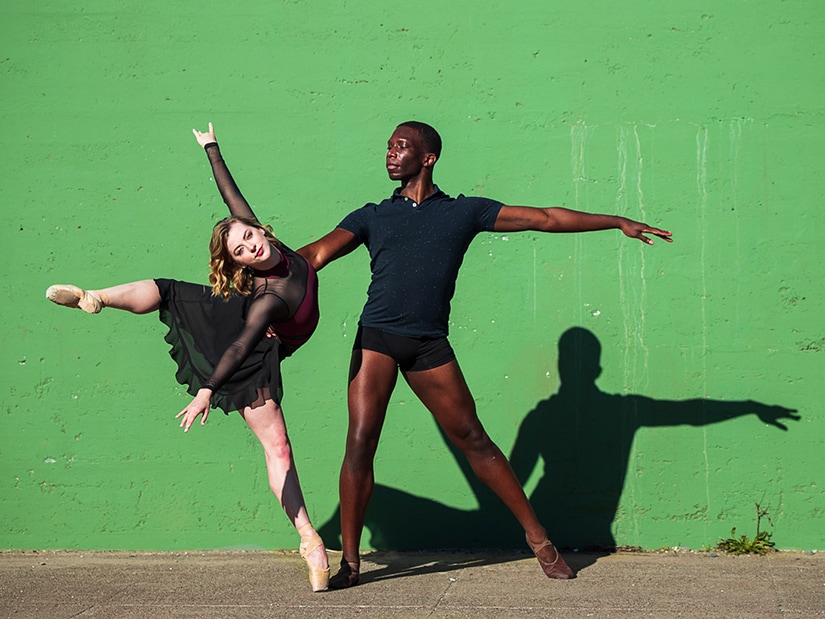 Brandon Alexander partnering with Cassidy Isaacson in front of striking green wall, photo by Chris Hardy