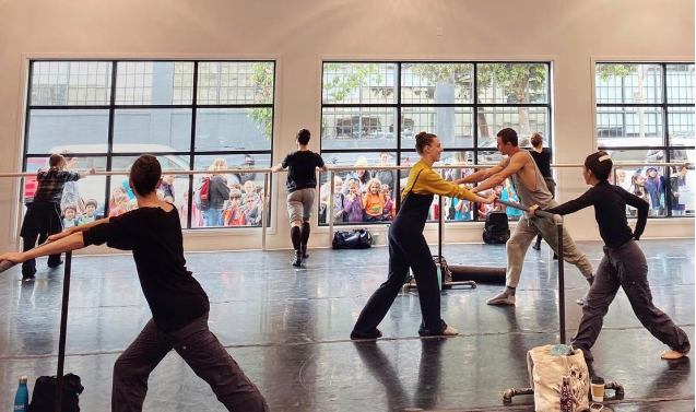 Kids watch Smuin dancers through studio window