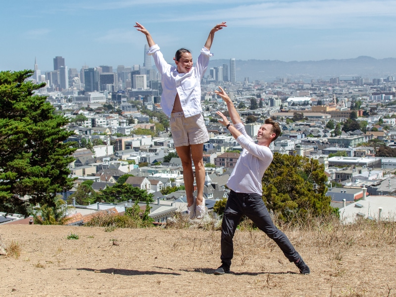 Terez and John dancing together with San Francisco in the background.