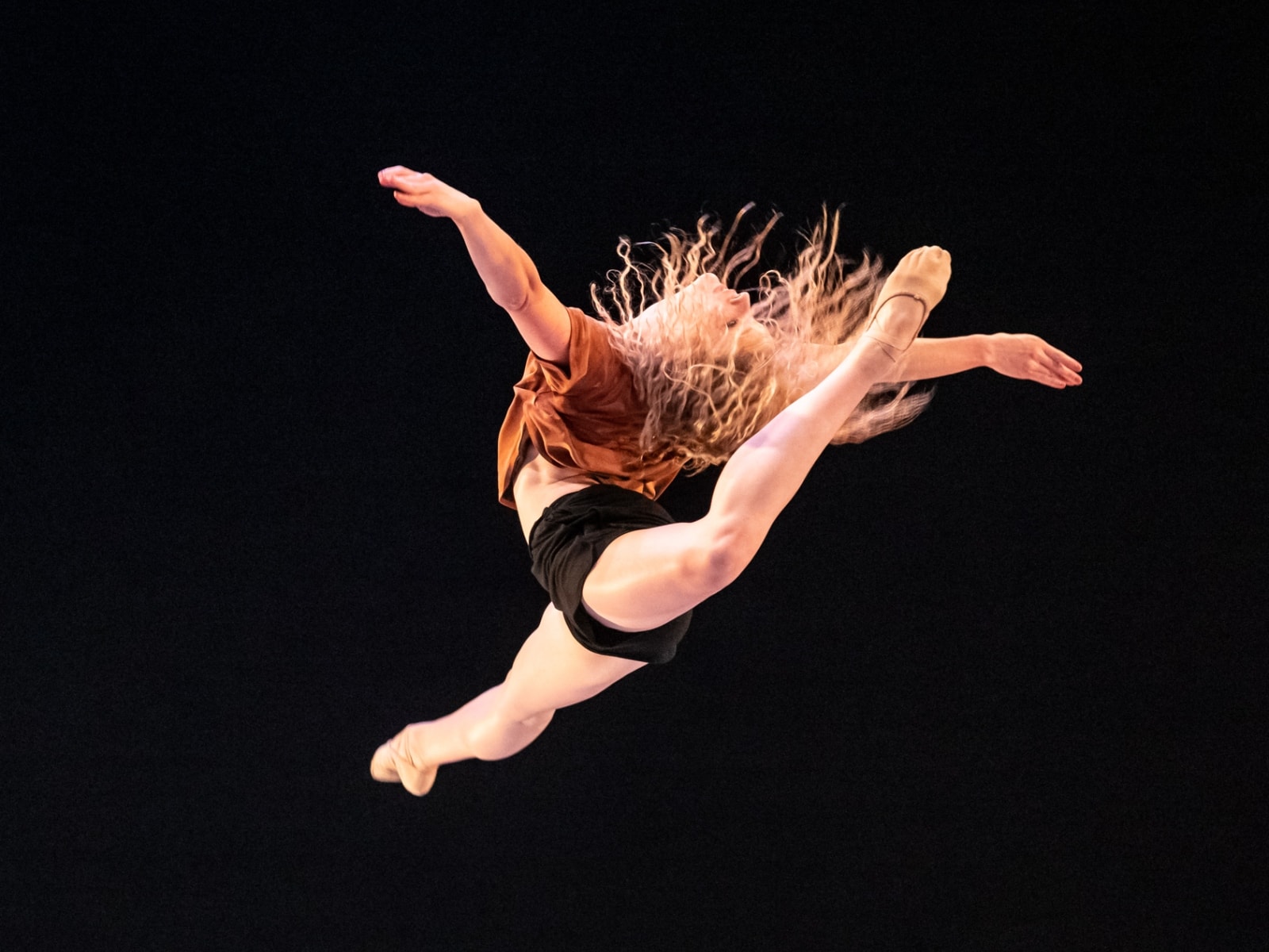 Tessa living in a big split jump! Photo by Chris Hardy