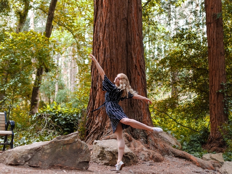 Tessa dancing in a forest of redwoods. By Maggie Carey